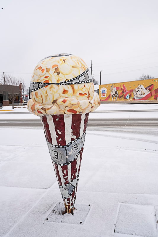 A giant ice cream cone sculpture greets students as they go from